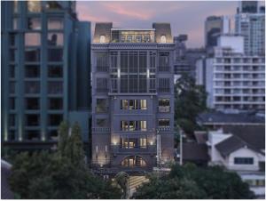 a tall building with lights on in a city at The Alberti Hotel - Sukhumvit 31 in Bangkok