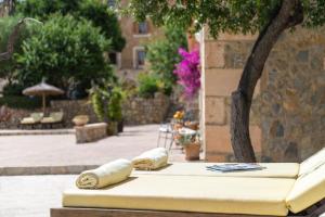 two rolled towels sitting on a table in a courtyard at Fincahotel Can Estades in Calvia Town
