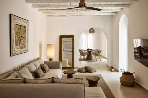 a living room with a couch and a table at Villa Soleil - Delmar Collection in Adamantas
