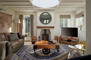 a living room with a couch and a fireplace at The Gatehouse at Pudleston Court in Hatfield
