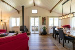 a living room with a red couch and a table at Chalet Bergblick in Wildhaus