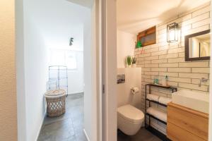 a bathroom with a toilet and a sink at Chalet Bergblick in Wildhaus +23 photos