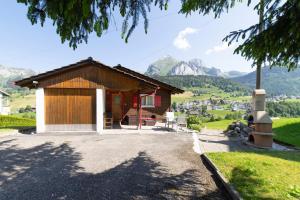 a small house with a view of mountains at Chalet Bergblick in Wildhaus
