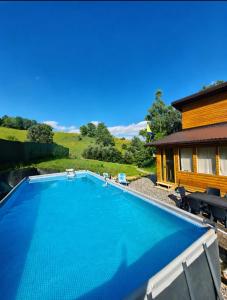 a swimming pool in front of a house at Kućica Sreće in Visoko