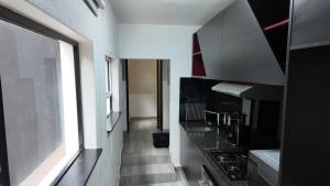a kitchen with black and white appliances and a window at Lora Gardens in Chartwell