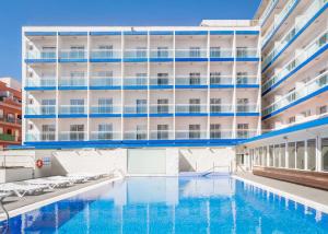 an empty swimming pool in front of a building at Hotel Festa Brava by ALEGRIA in Lloret de Mar