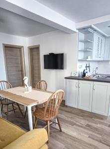 a kitchen and dining room with a table and chairs at Maestral in Nerezine