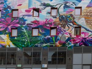 a mural on the side of a building with flowers at ibis budget Swindon Town Centre in Swindon
