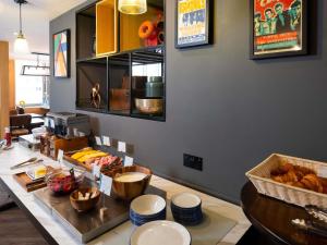 a kitchen with a counter with some food on it at ibis budget Swindon Town Centre in Swindon