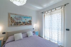 a bedroom with a bed and a window at Residence il Gabbiano in Palau +110 photos