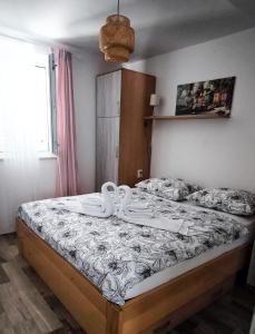 a bedroom with a bed with two swans on it at Maestral in Nerezine