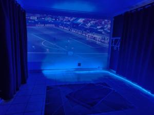a room with a tennis court in a blue room at The Corner Lounge - Lenasia in Lenasia