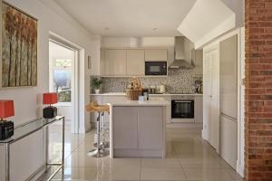 a kitchen with white cabinets and a counter top at Ponds View at Pudleston Court in Docklow +21 photos