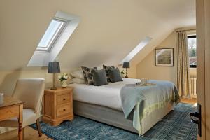 a bedroom with a bed and a chair at Ponds View at Pudleston Court in Docklow