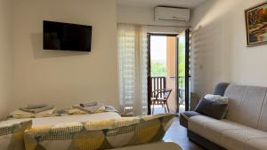 a living room with a bed and a couch at Neo3 in Veliko Gradište