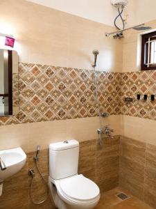 a bathroom with a toilet and a sink at Serene Padmanabham Premium Luxury Apartments Near Sree Padmanabhaswamy Temple in Trivandrum +20 photos