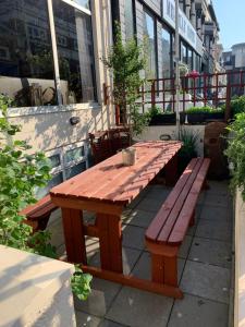 a wooden table and bench sitting outside of a building at Boomerang Blackpool in Blackpool
