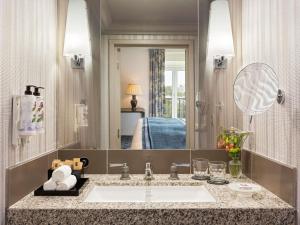 a bathroom with a sink and a mirror at Le Royal Hotel Lyon - MGallery Collection in Lyon