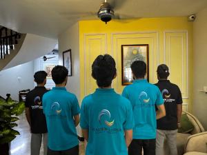 a group of men in blue tshirts standing in a room at Seaview lodge Executive in Karachi +44 photos