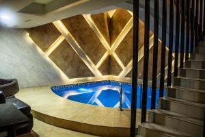 a swimming pool in a building with a ceiling at Mirage Hotel in Yerevan