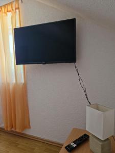a flat screen tv hanging on a wall at Duvnjak Rooms & House in Livno