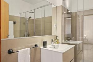 a bathroom with a sink and a mirror at Driftwood - Refúgio Perto do Mar in Matosinhos +20 photos