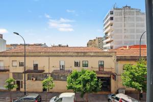 an old building with cars parked in a city at Driftwood - Refúgio Perto do Mar in Matosinhos