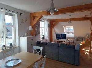 a living room with a couch and a table at Baltic Sea in Jastarnia +3 photos