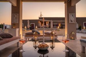 a living room with two glasses of wine and a table at Villa Brigida Resort - Soft Luxury Atmosphere - Adult Oriented in Santeramo in Colle
