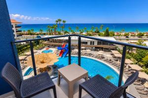 a balcony with a view of a pool and the ocean at World Star Beach Resort & Spa in Alanya