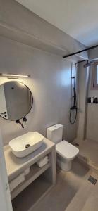a bathroom with a sink and a toilet at REYA suites in Aliki +26 photos
