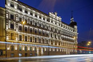a large building with lights on the side of it at Aparthotel Amella in Riga
