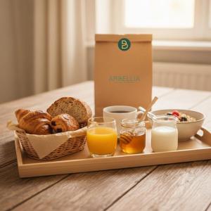 a tray of breakfast foods and a box of milk at ARBELLIA Appart'Hôtel Châlons en Champagne in Chalons en Champagne