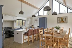 a kitchen and dining room with a table and chairs at Rosehaven House at Pudleston Court in Docklow