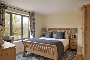 a bedroom with a bed and a large window at Rosehaven House at Pudleston Court in Docklow +16 photos