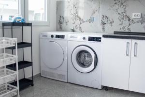 a white washing machine sitting in a laundry room at Motel Nova in Strumica