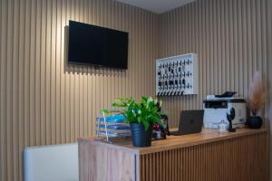 a room with a table with a television on a wall at Motel Nova in Strumica +7 photos