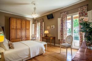 a bedroom with a bed and a desk and a window at L’Hort de Sant Cebrià in Torroella de Fluviá +49 photos