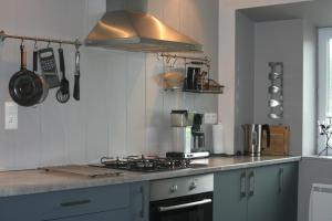a kitchen with a stove top oven in a kitchen at Gîte Ti-Maes in Briec +33 photos