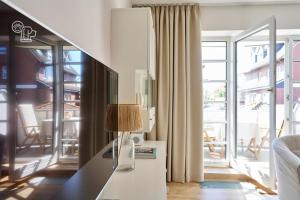 a living room with a table with a lamp on it at Haus Nordstrand in Norderney