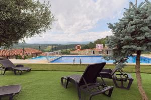 a group of chairs sitting next to a swimming pool at Pensión Casa Felisa in Monforte de Lemos