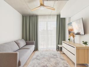 a living room with a couch and a table at NanoApart by Solarento in Warsaw