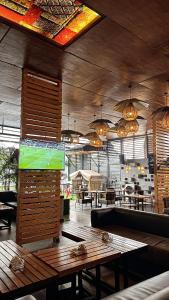 a restaurant with a table and a tv in a room at Grand Riviera Hotel in Port Harcourt