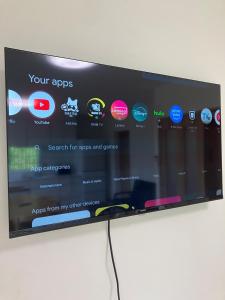a television screen with a bunch of apps on it at Ocean view Private Hotel in Shimoda