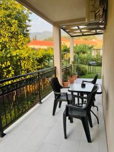 a patio with a table and chairs on a balcony at Vila CarpeDiem in Herceg-Novi