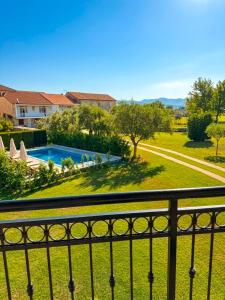 a view from a balcony of a yard with a swimming pool at Vila CarpeDiem in Herceg-Novi