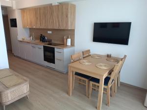 a kitchen and dining room with a table and chairs at Apartament 512 in Dziwnówek
