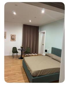 a bedroom with a bed and two chairs and a table at Sanleucio SILK ROOM in Caserta