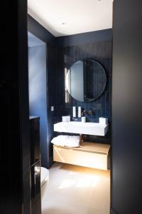 a bathroom with a sink and a mirror at Hôtel Casa Elena in Erbalunga