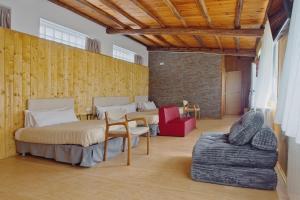 a room with four beds and a couch and a brick wall at Vivienda Jardin in Monforte de Lemos +82 photos